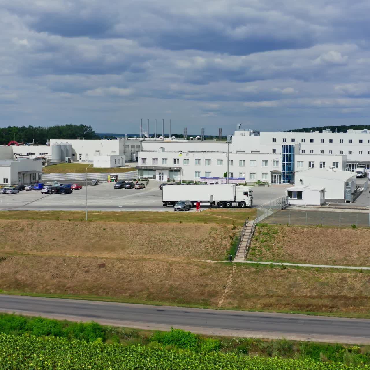 Agricultural facilities built in field. Modern factory buildings. Newly built big modern plant in rural area. Video from dron