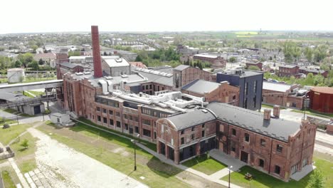 exterior view of sugar factory with smokestack - industrial plant in znin, poland