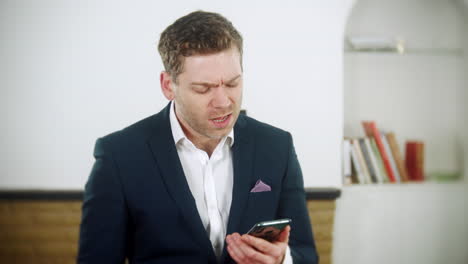 young businessman is using an app on his phone