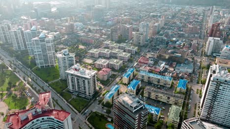 Aerial-dolly-in-of-modern-apartment-complex-and-buildings-in-ViÃ±a-del-Mar-near-sea-and-sand-shore,-Chile