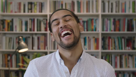 close-up-portrait-of-handsome-young-hispanic-man-student-laughing-cheerful-in-library-study-background-enjoying-learning-education