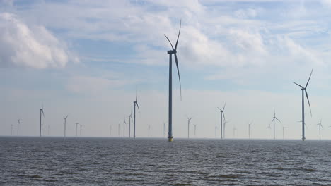 Campo-De-Turbinas-Eólicas,-Toma-Panorámica,-En-El-Lago-Ijssel-De-Los-Países-Bajos,-Europa