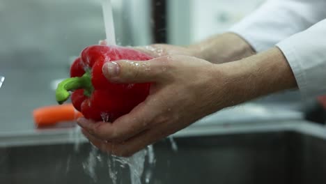 washing a red bell pepper