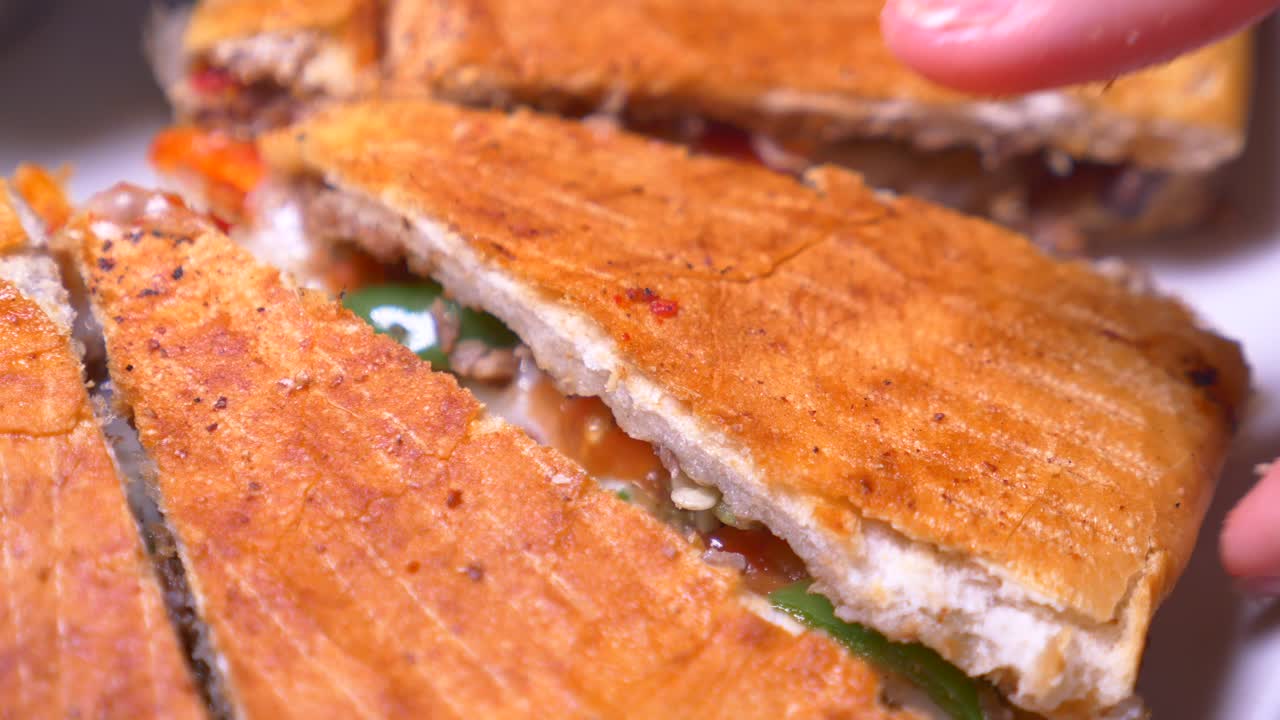Hand picking up a slice of Turkish Pide
