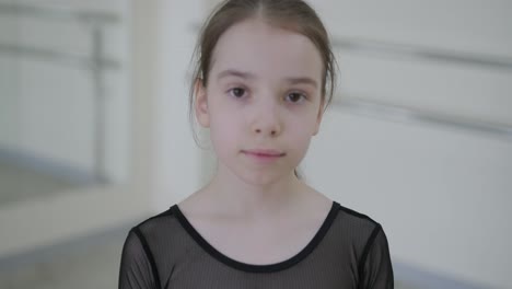 young ballet girl at studio lesson. training performance. stretching exercise pose. ballerina practice balance technique. classical elegance fitness.