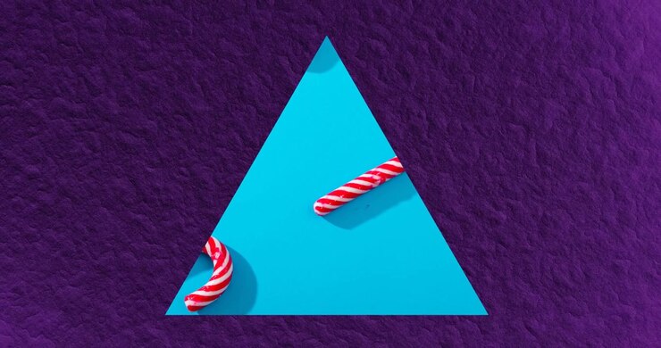 Animation of triangle frame with christmas candies on blue background