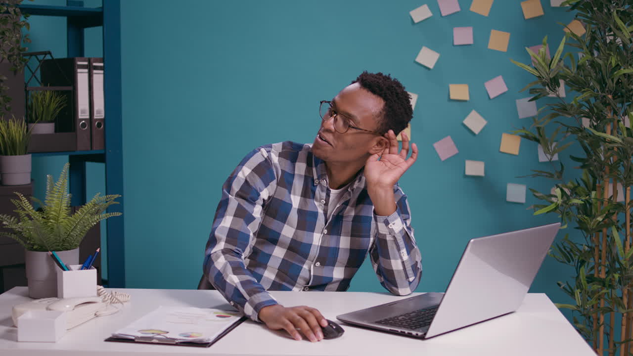 African american man listening to gossip and rumor at laptop