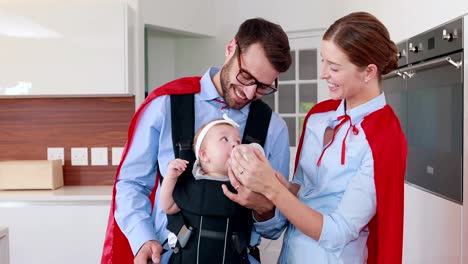 Parents-with-red-cloak-feeding-their-baby