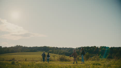 friends exploring meadow while walking against sky