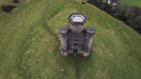 aerial: top down reveal of paxton's tower, carmarthen, 4k drone