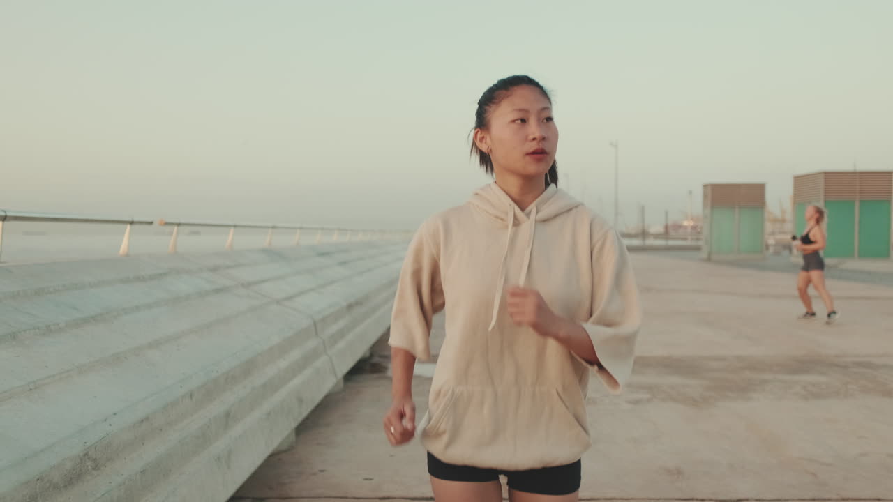 Asian woman jogging on the beach