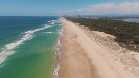 drone captures ocean waves and sandy beach