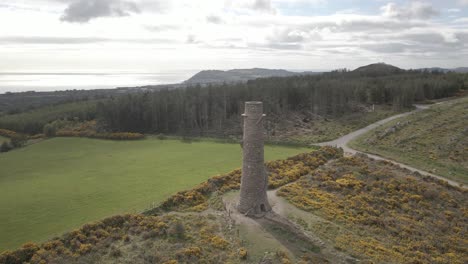 aerial view of the ruin of the flue chimney at ballycorus, dublin, ireland - drone shot