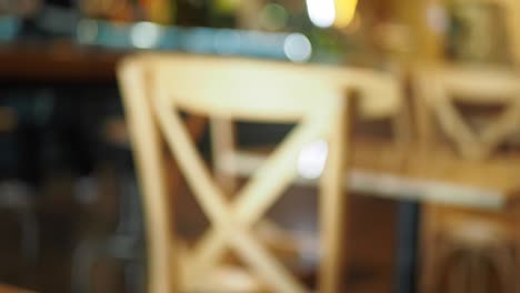 blurred restaurant interior with wooden chairs