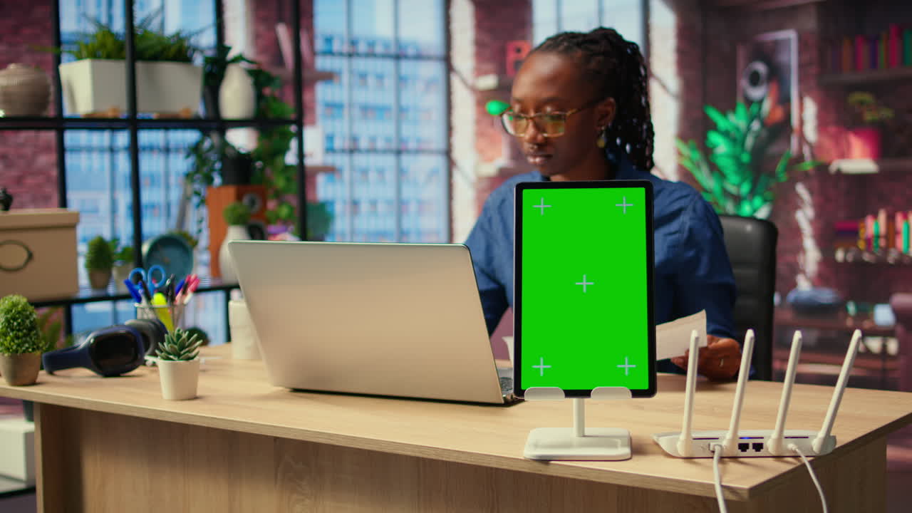 la chica negra trata de arreglar el error del wi-fi reiniciando el enrutador junto a la pantalla aislada