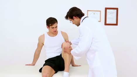 physiotherapist moving patients knee