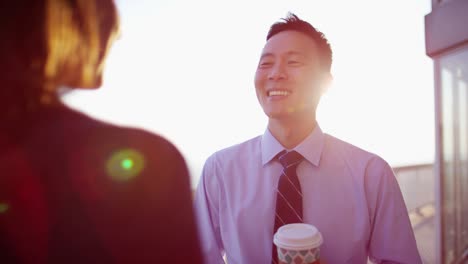 smiling multi ethnic business couple enjoying coffee break