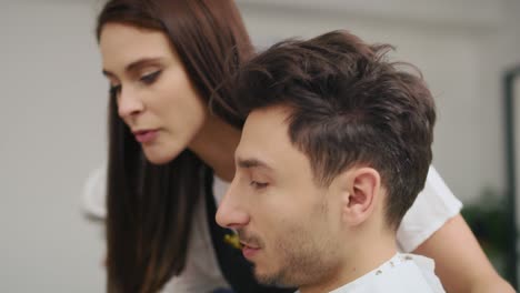 Handheld-view-of-customer-showing-which-hairstyle-he-wants