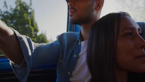 young couple on a road trip in their pick-up truck