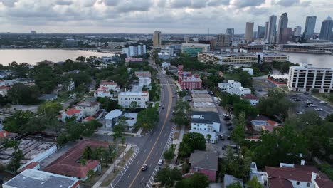 traffic scene on road at bayshore of tampa city at dusk. aerial wide shot. downtown skyline with skyscrapers in distance. florida, usa.