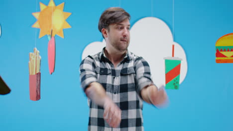man with a displeased expression in front of fast food decorations
