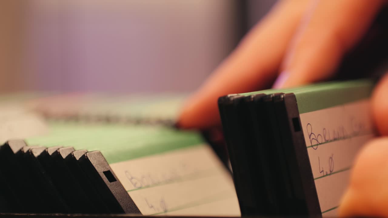 Using diskette for old computer. Music recorder, playing retro computer games. Vintage device for office, obsolete technology. . High quality 4k footage