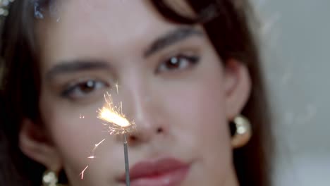 the lighting of a firework sparkler, in the background a female model dreams away