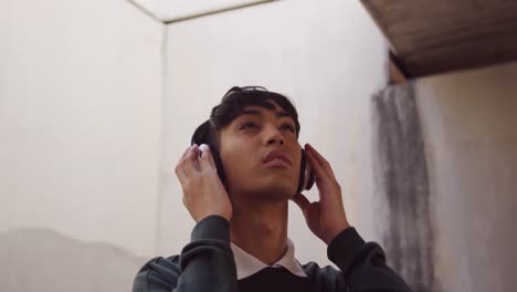 transgender adult listening to music in the street