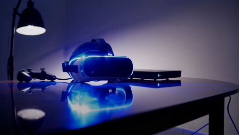 vr headset and gaming console on a table at night