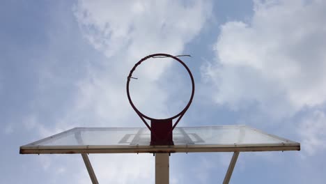 a basketball hoop with moving cloud background