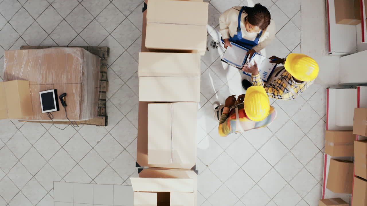 Warehouse workers reviewing inventory