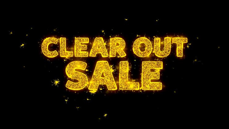 Clear Out Sale Text Sparks Particles on Black Background.