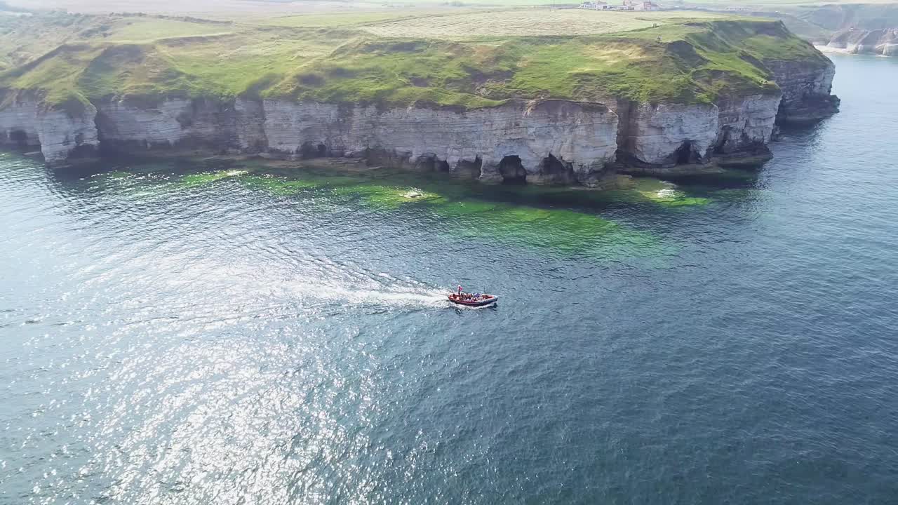 잔잔한 파도가 바위를 찰싹 때리는 흰색 분필 해안 절벽의 멋진 전망