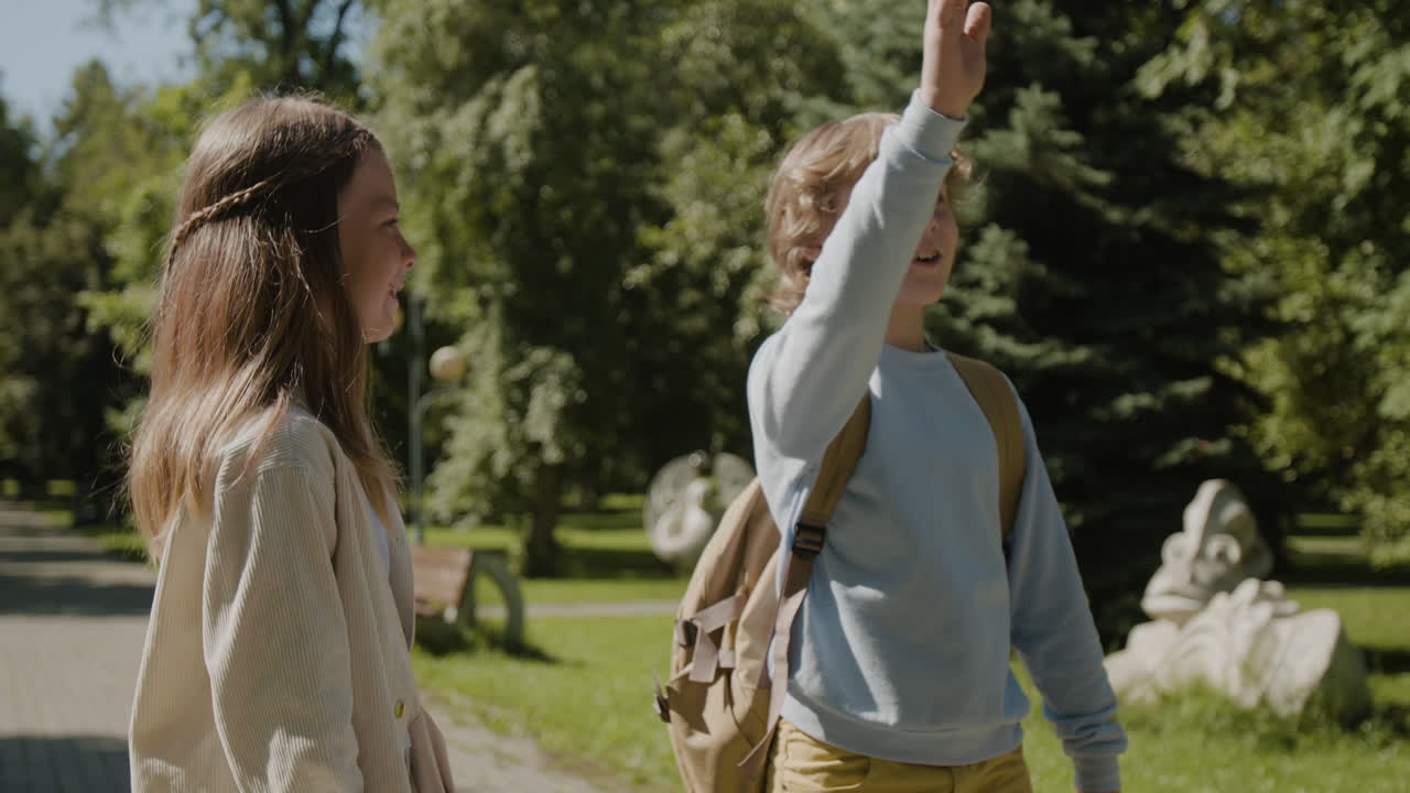 Kids talking and interacting in a sunny park