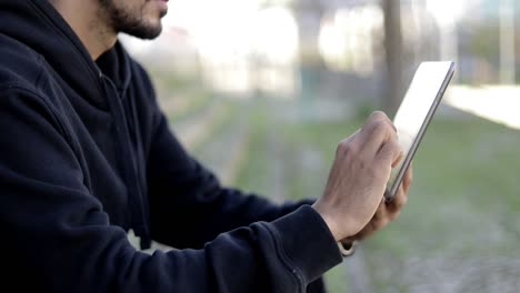 Cropped-shot-of-man-using-tablet-pc