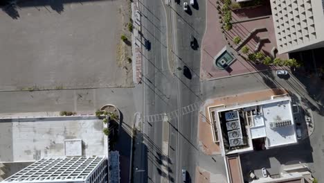 intersection in downtown tucson, arizona with traffic moving and drone video overhead looking down
