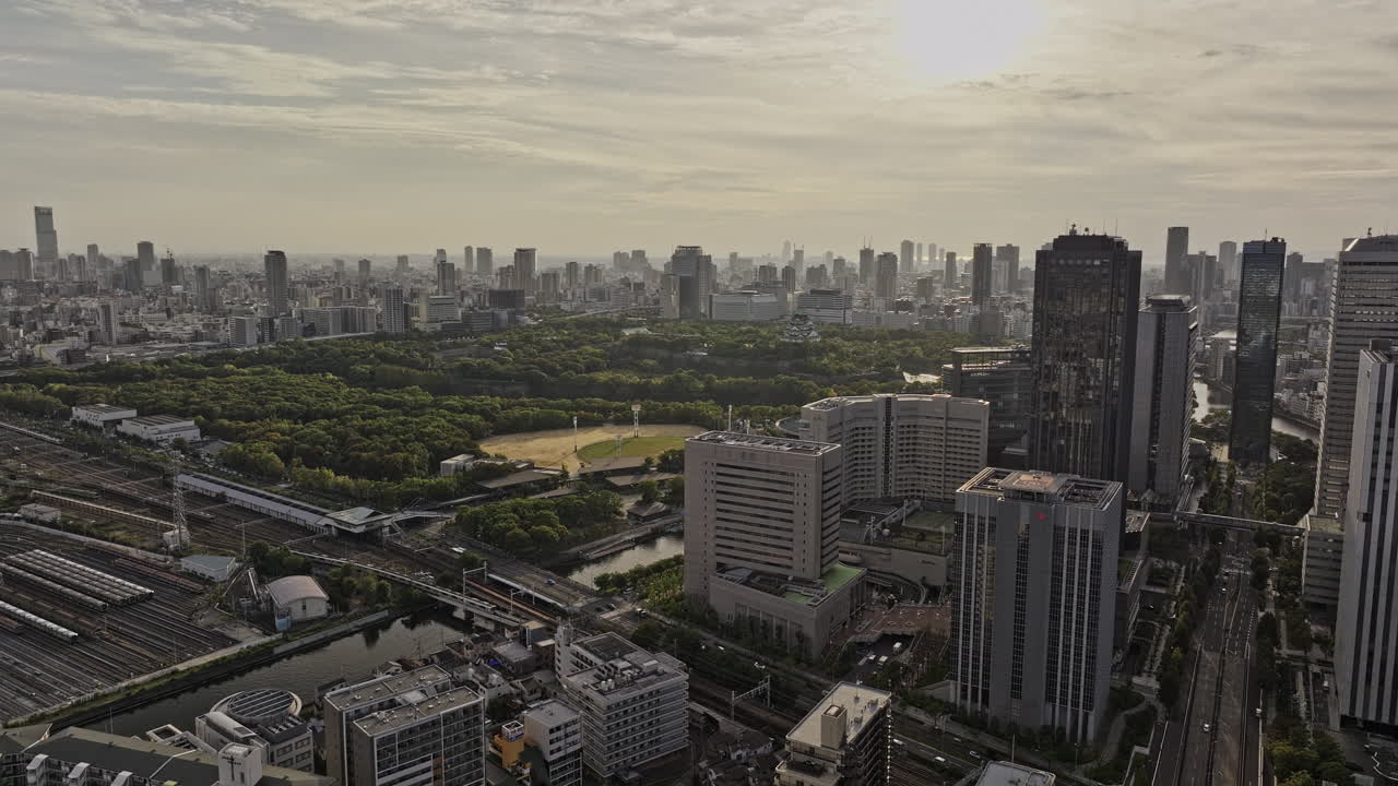 Osaka Japan Aerial v71 flyover Shiginonishi capturing views of Daini Neya river, Osakajo park, railway station and Chuo Ward downtown cityscape at sunset - Shot with Mavic 3 Pro Cine - Oct 9th 2023