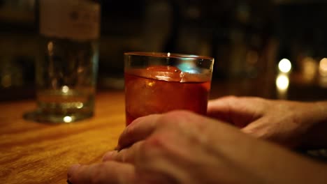 hands making and serving a cocktail drink