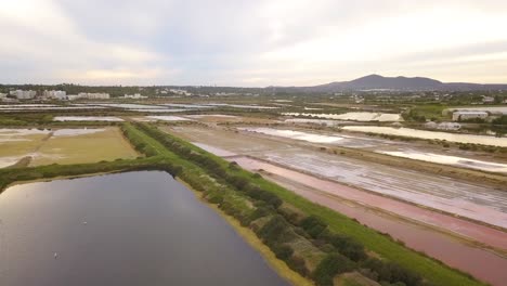 Aerial-drone-pull-out-clip---Salt-pans-of-Fuseta-Portugal-during-a-beautiful-sunset-over-the-Algarve