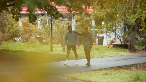 two men walking in a park