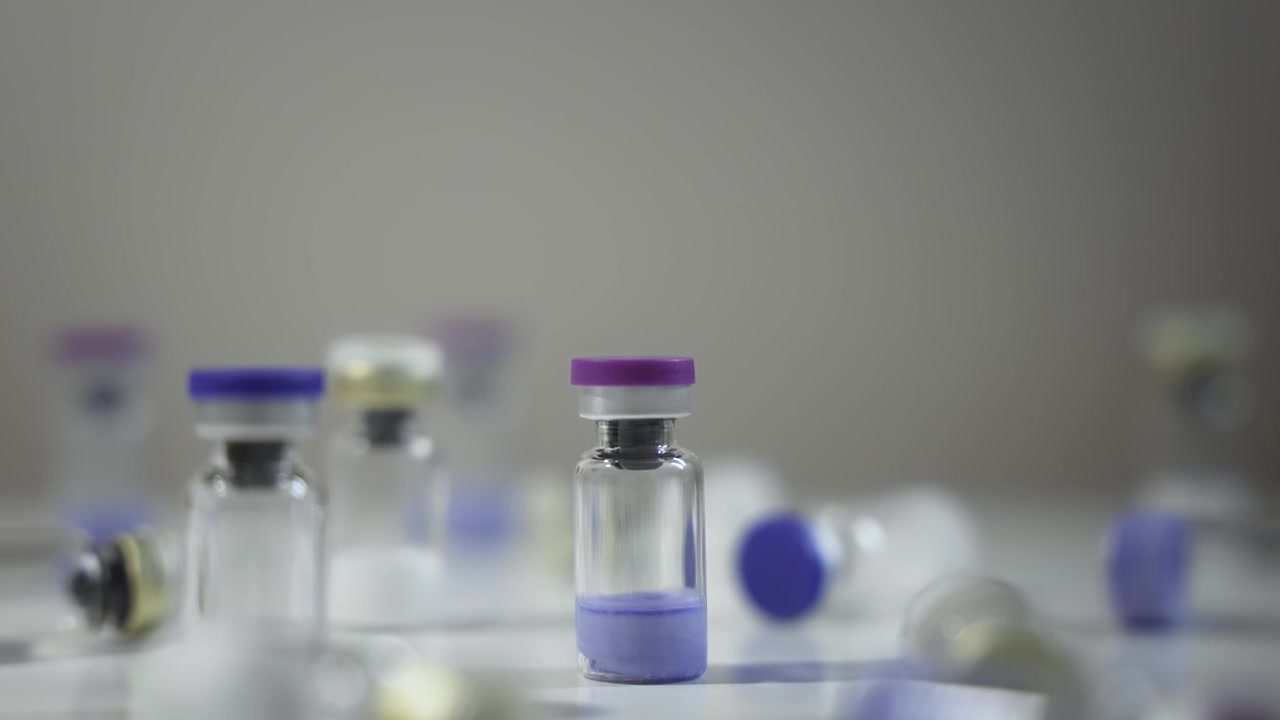 Pharmaceutical Vials with Colorful Caps, Slow Dolly Shot [Peptide Concept]