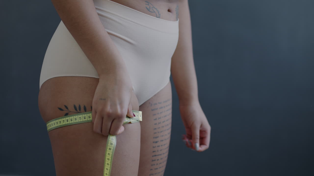 Woman Measuring Her Thighs