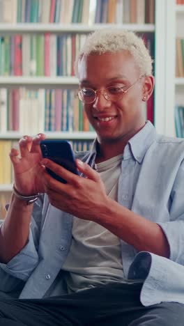 young joy african american man holding mobile phone in hands pressing screen
