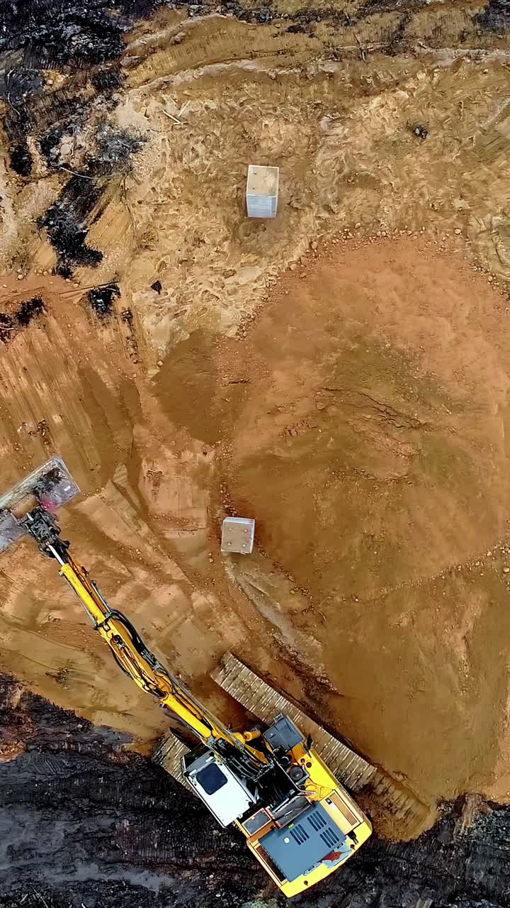 Drone top down of sandy construction zone with exposed concrete base structures