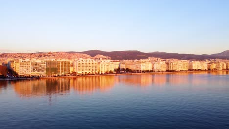 Thessoloniki-Waterfront-at-Sunset,-Aristotle-Square,-Upward-Camera-movement-to-reveal-City