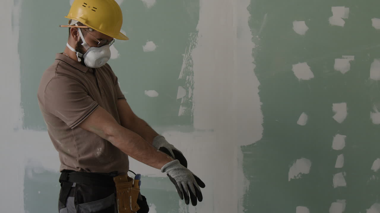 Construction Worker Preparing Drywall for Repair
