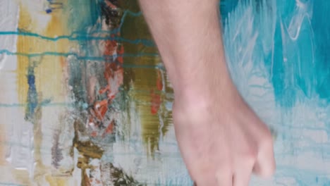 artist creating abstract painting on canvas this image features an artist engaged in painting on canvas showcasing an abstract artwork the scene is colorful and vibrant depicting the creative process typical of a workshop setting the focus is on the artist skillfully using a brush allowing for an ex