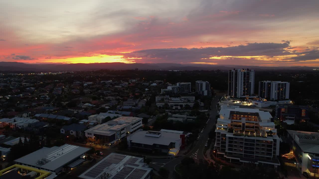 Modern Buildings And Suburban Landscape Along Varsity Parade At Sunset. Varsity Lakes In Queensland, Australia. pullback drone shot