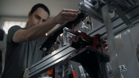 person working on precision equipment in a workshop