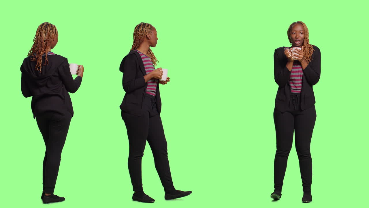 Young African-American Woman Enjoys a Warm Drink in Studio